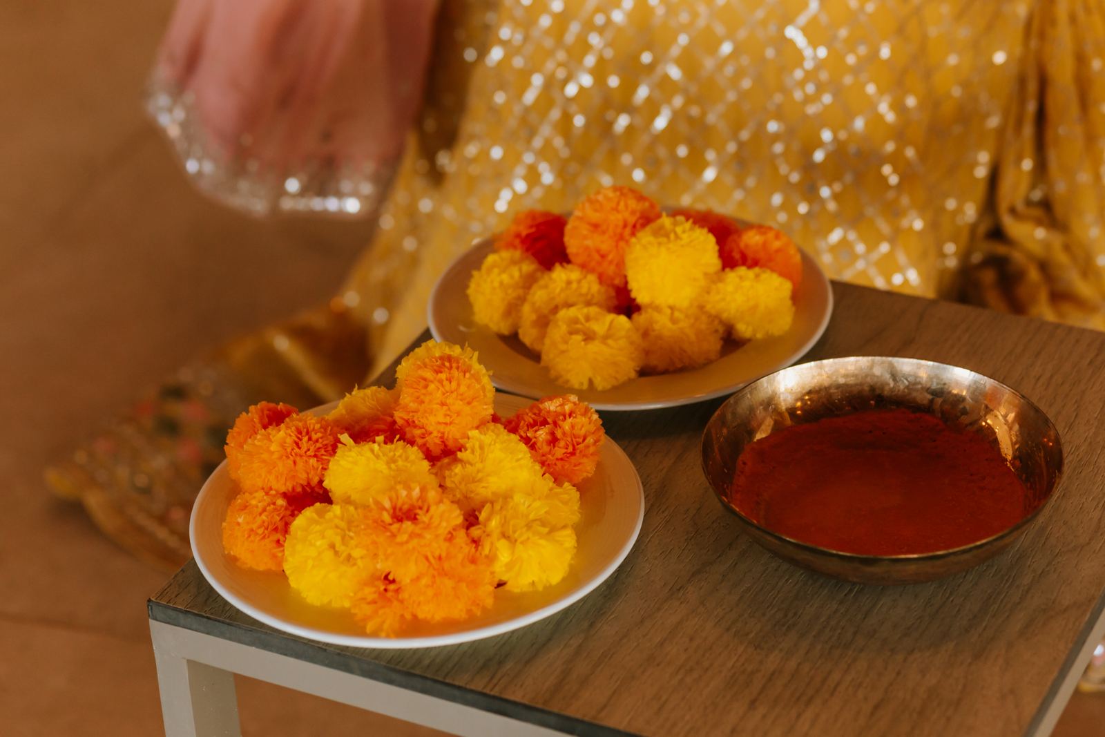 Bowls of marigolds and turmeric paste set out for a haldi