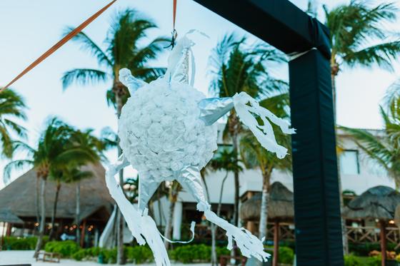 A white paper decoration with streamers hanging over the reception