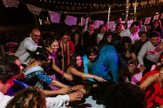 Guests crowding down onto the dance floor, arms out