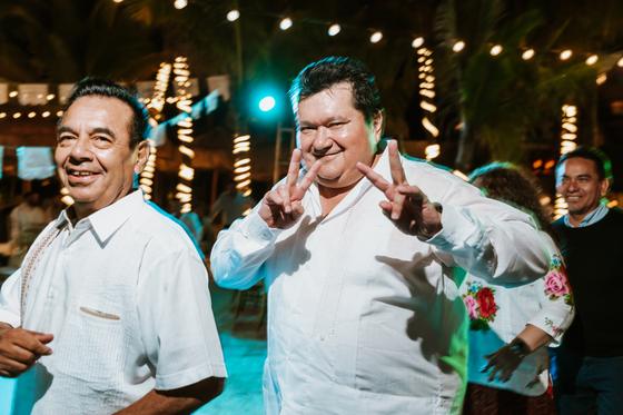 Two guests in guayaberas grinning for the camera