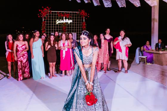 The bride with her bouquet before the toss, guests waiting behind