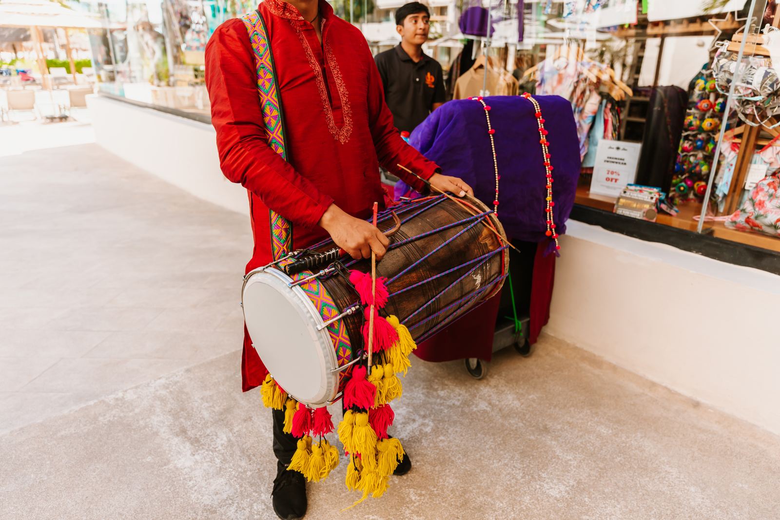 Hands striking the dhol during a baraat